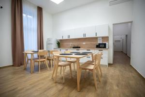 a kitchen with a table and chairs in a room at Quasi Rooms in Eger