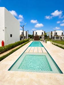 a swimming pool in the backyard of a house at Eco Avalon Paradise Villa in Punta Cana