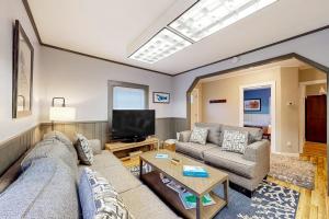 a living room with a couch and a tv at Open layout Maine cottage with washer/dryer & grill - dog-friendly in Gouldsboro