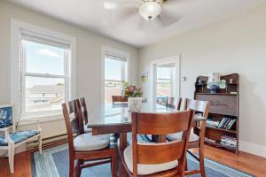 a dining room with a table and chairs at Admiral's Quarters in Boothbay Harbor