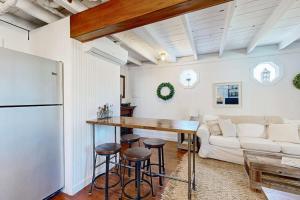 a kitchen and living room with a table and a couch at Iconic downtown retreat with firepit & fireplace- walk to Harbor Footbridge in Boothbay Harbor