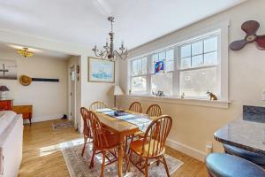 a dining room with a table and chairs at Coastal bungalow with large yard, beautiful kitchen, & great location in Boothbay Harbor +17 photos