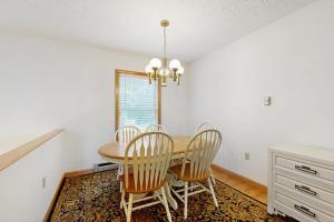a dining room with a table and chairs at Townhome w/ Bonus Loft, High-Speed WiFi, Partial AC & Full Kitchen in Bar Harbor