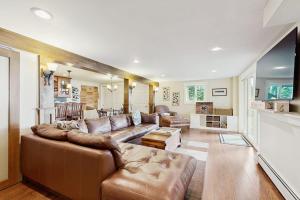 a large living room with a couch and a table at Oceanfront snowbird-friendly home on the beach with washer/dryer & fireplace in Lincolnville