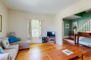 a living room with a couch and a tv at Parker House: Historic home - walk downtown, dog-friendly & washer/dryer in Camden