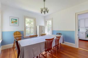 a dining room with a white table and chairs at Parker House: Historic home - walk downtown, dog-friendly & washer/dryer in Camden