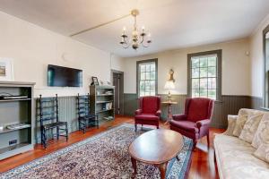 a living room with a couch and chairs and a tv at National Historic Landmark Home in Wiscasset Village w/ Complimentary Tour in Wiscasset