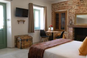 a bedroom with a bed and a brick wall at Cascina Bella - Piozzo in Piozzo