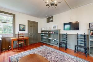 a living room with a table and chairs and a tv at National Historic Landmark Home in Wiscasset Village w/ Complimentary Tour in Wiscasset