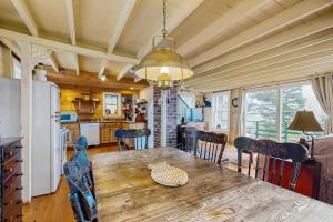 a kitchen and dining room with a wooden table and chairs at Bayfront cottage with fantastic views & minutes to downtown - Dog-friendly in Boothbay Harbor +19 photos