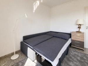 a bedroom with a bed and a desk and a lamp at Kiek ut in Stein