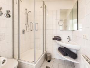 a bathroom with a shower and a sink and a toilet at Kiek ut in Stein +16 photos