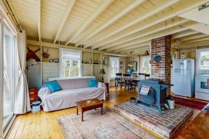 a living room with a bed and a fireplace at Bayfront cottage with fantastic views & minutes to downtown - Dog-friendly in Boothbay Harbor