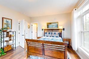 a bedroom with a wooden bed and a window at Secluded hilltop home with beautiful Cadillac Mountain view and multiple decks in Bar Harbor +31 photos
