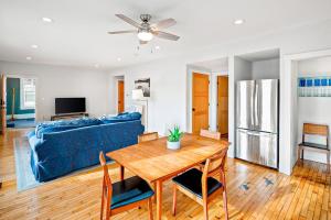 a living room with a table and a blue couch at Waterfront, walkable home with beautiful kitchen & washer/dryer - dog-friendly in Camden