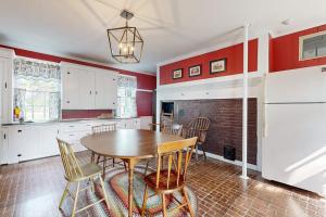 a kitchen with a wooden table and chairs at National Historic Landmark Home in Wiscasset Village w/ Complimentary Tour in Wiscasset +21 photos