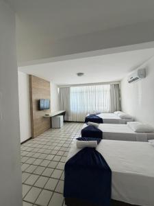 a row of beds in a hotel room at Praia Hotel Enseada in Maceió +33 photos