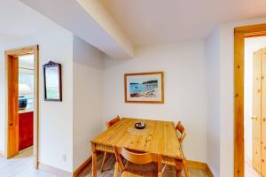 a dining room with a wooden table and chairs at Dog-friendly ocean-view home with grill, wood stove, deck, washer/dryer, & AC in Southwest Harbor