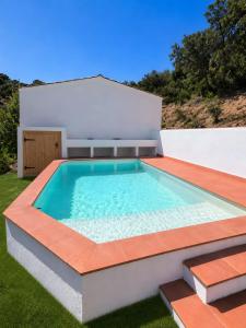 a swimming pool in the backyard of a house at Masía Can Garriga, Casa Gran in Girona