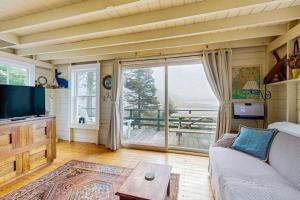 a living room with a couch and a large window at Bayfront cottage with fantastic views & minutes to downtown - Dog-friendly in Boothbay Harbor