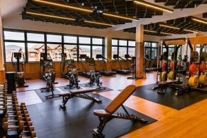 a gym with treadmills and exercise equipment in a building at The Outpost by Windham Mountain Club in Windham