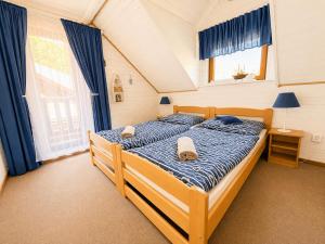 a bedroom with a bed with two towels on it at Chalet Velora in Oščadnica