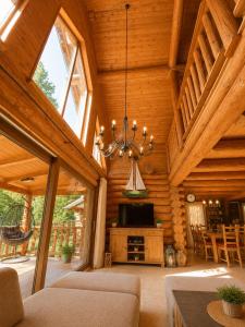 a living room in a log cabin with a chandelier at Chalet Velora in Oščadnica