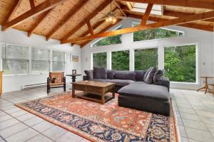 a living room with a couch and a table at Tranquil private riverfront home w/ tidal dock & large yard in Boothbay