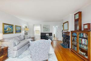 a living room with a couch and a table at Elegant Historic Home with Refined Interiors and Private Outdoor Spaces in Camden