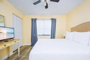 a bedroom with a bed and a flat screen tv at Lei Lani 108 condo in Orange Beach +30 photos