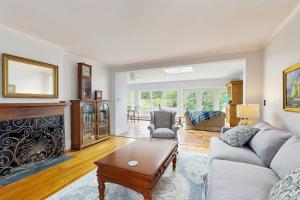 a living room with a couch and a fireplace at Elegant Historic Home with Refined Interiors and Private Outdoor Spaces in Camden