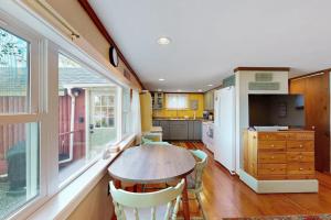 a kitchen with a table and chairs in a room at Secluded lakefront cottage great views, dock & boat launch in Ellsworth
