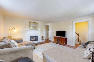 a living room with a couch and a television at Classic home with prime location 1 block from Main Street in Bucksport