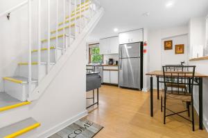 a kitchen and dining room with a staircase in a house at Two-Level Unit w/ Patio, Deck, Firepit, Private Washer/ Dryer, and Free WiFi in Seal Harbor