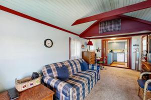 a living room with a couch and a table at Secluded lakefront cottage great views, dock & boat launch in Ellsworth