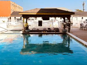 a swimming pool with a gazebo in a yard at Oceanic Hotel in Wildwood