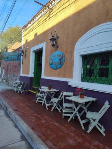 a group of picnic tables outside of a building at Portal de las Viñas in Cafayate