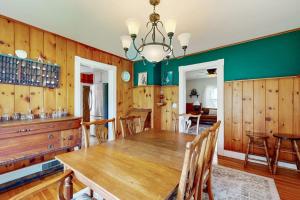 a dining room with a wooden table and chairs at Coastal Serenity Retreat with Ocean Views, Spacious Porch and Modern Comforts in Sullivan