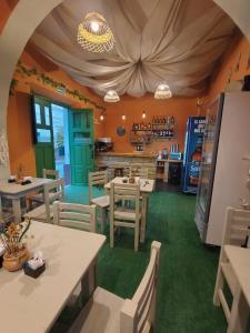a restaurant with tables and chairs in a room at Portal de las Viñas in Cafayate