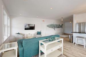 a living room with a couch and a table at Elegant Oceanfront Condo with Stunning Harbor Views & Spectacular Sunsets in Boothbay Harbor