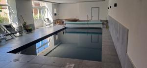 a swimming pool in the middle of a room at Hoeve Jadoul in Gingelom