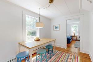 a dining room with a table and four chairs at Tranquil Seaside Cottage with Spectacular Views, Wifi & Washer/Dryer in Boothbay