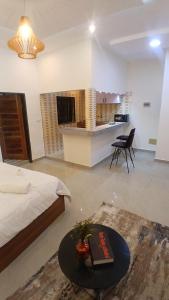 a bedroom with a bed and a table in a room at PaoLia Meublé 3 in Cotonou