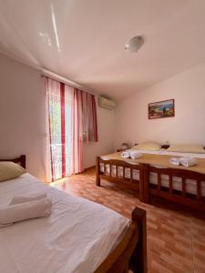 a bedroom with two beds and a window at Studio Apartments Ivo in Baška Voda