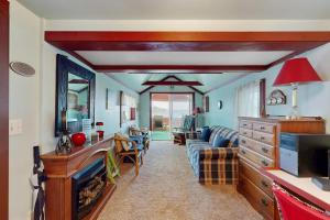 a living room with a couch and a tv at Secluded lakefront cottage great views, dock & boat launch in Ellsworth