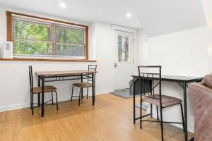 a living room with two tables and chairs and a couch at Two-Level Unit w/ Patio, Deck, Firepit, Private Washer/ Dryer, and Free WiFi in Seal Harbor +26 photos