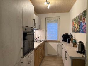 a kitchen with a sink and a window in it at Ferienhaus Am Vitzerod in Tambach-Dietharz