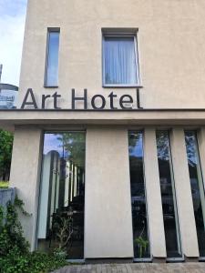 a building with a sign that reads art hotel at Art Hotel Podebrady in Poděbrady