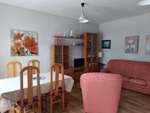 a living room with a table and a couch at Casa Montse - Derecha in Colombres