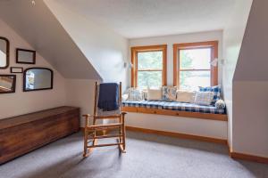 a room with a couch and a chair and a window at Gorgeous lakefront home w/ dock, canoe, kayaks & lake/forest views in Ellsworth